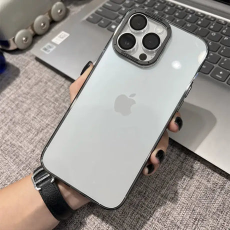 a person holding an iphone case with a keyboard in the background