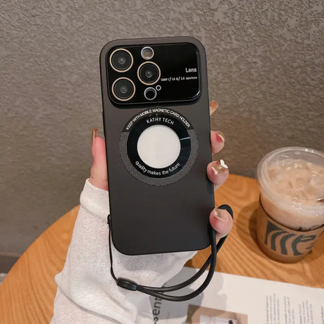 a woman holding a black iphone case with a white button