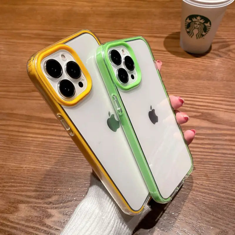 a person holding a green and yellow iphone case