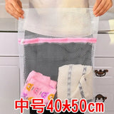 a person holding a mesh bag with a small bag inside