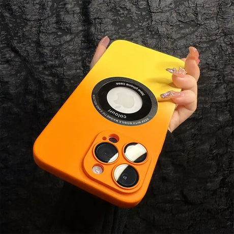 a hand holding an orange case with a camera