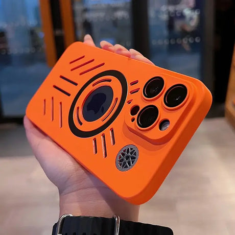 a person holding an orange iphone case