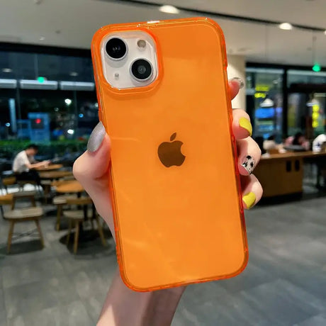 a person holding an orange iphone case