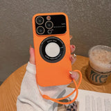 a woman holding an orange iphone case with a camera attached to it