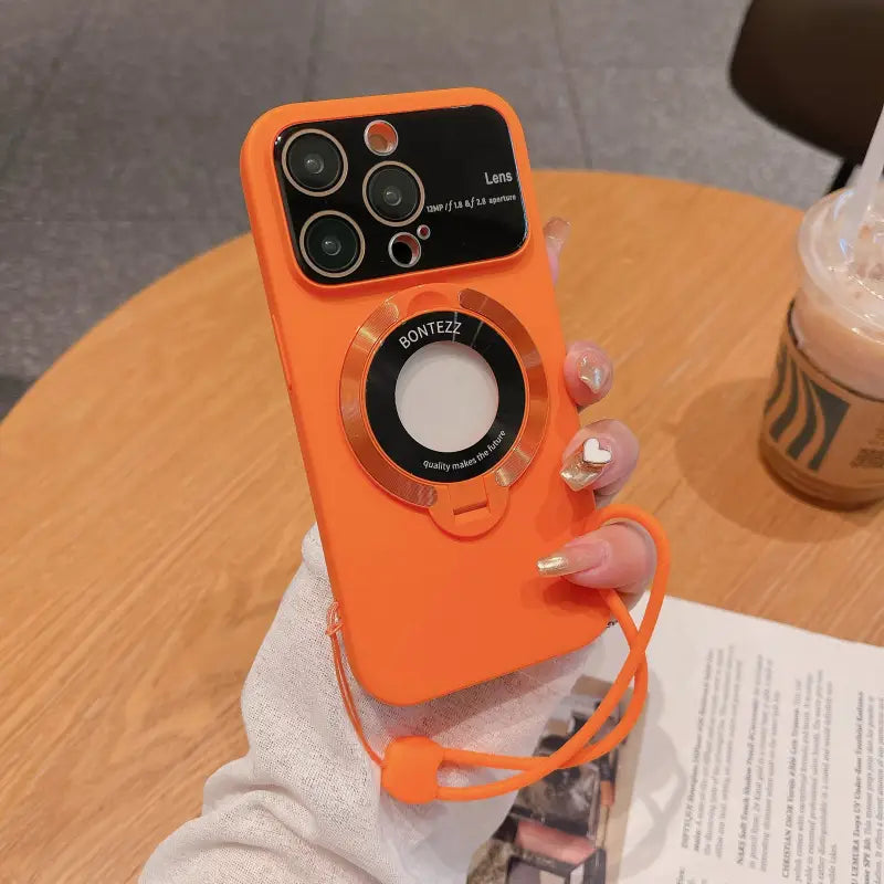 a person holding an orange phone case