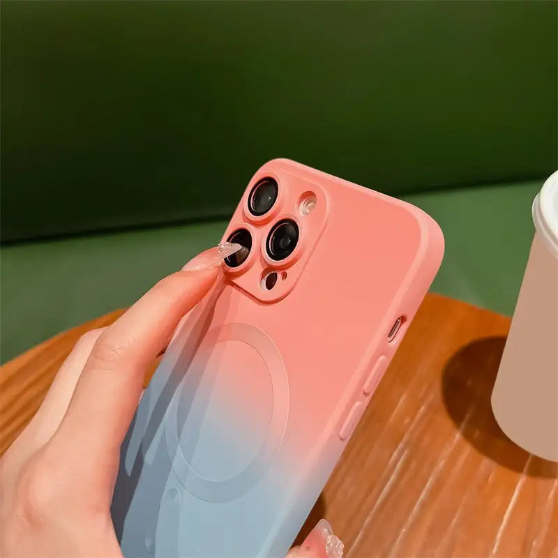 a person holding a phone with a cup in the background