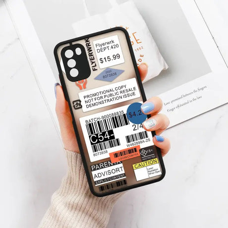 a person holding a phone with a barcode sticker on it