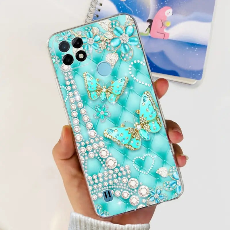 a person holding a phone with a blue case with a diamond butterfly