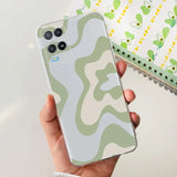 a person holding a phone with a camouflage pattern on it