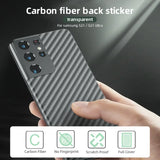 a person holding a phone with carbon fiber back sticker