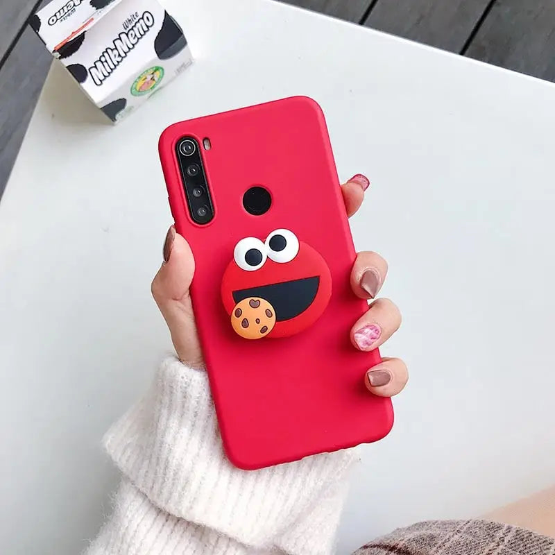 a woman holding a red phone case with a red bird on it