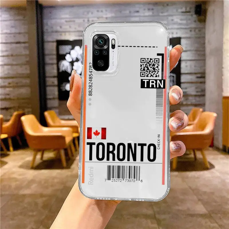 a hand holding a white iphone case with the toronto logo on it