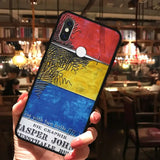 a person holding up a phone case with a painting on it
