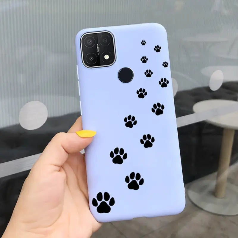 a person holding a phone case with a dog paw print