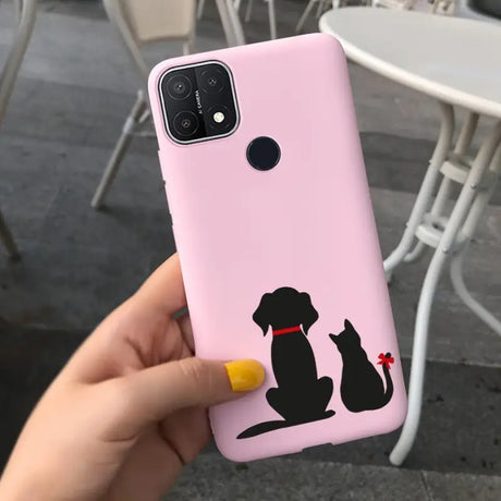 a woman holding a pink phone case with a black cat on it