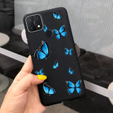 a woman holding a phone case with blue butterflies on it