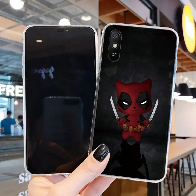 a close up of a person holding a phone with a deadpool phone case