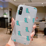a person holding a phone case with a dinosaur pattern