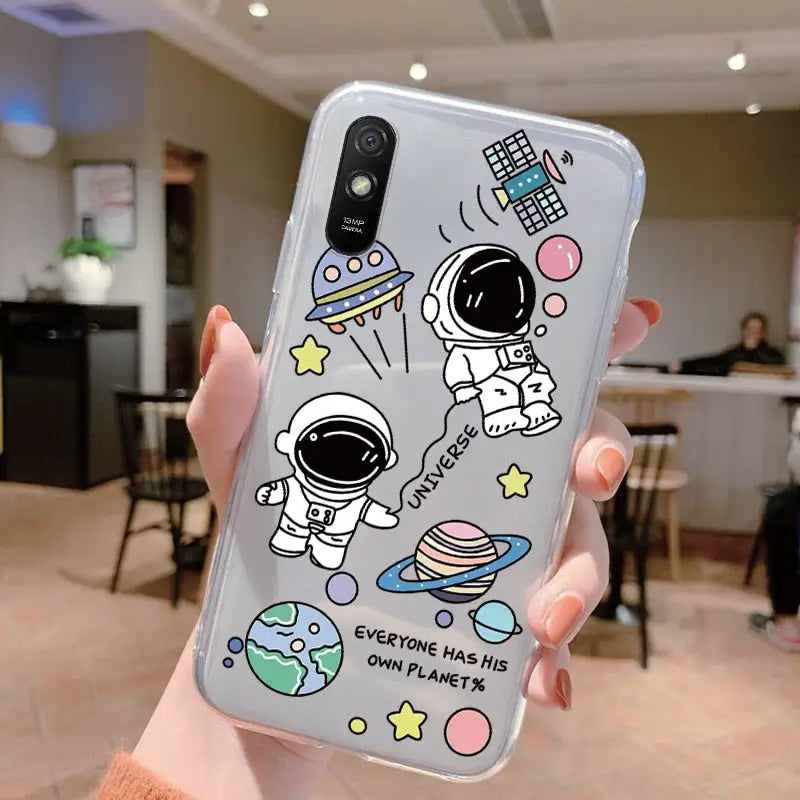 a person holding a phone case with space themed illustrations