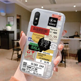 a person holding up a phone case with a sticker on it