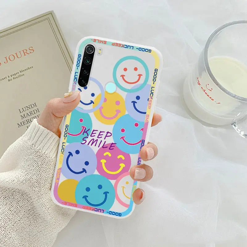 a person holding a phone case with a colorful pattern