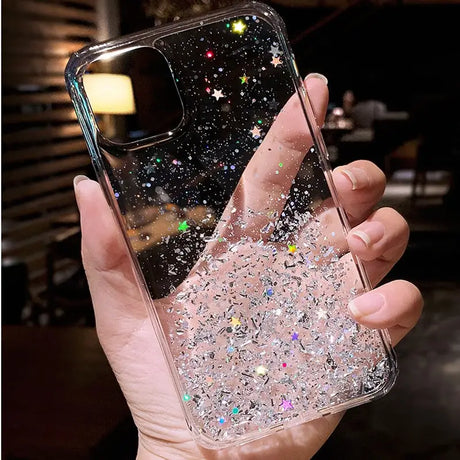 a person holding a phone case with glitter