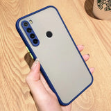 a person holding a phone case on a table