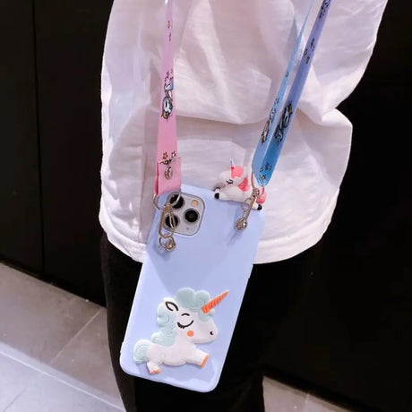 a woman holding a phone case with a unicorn on it