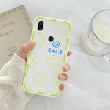 a person holding a phone case with smiley face