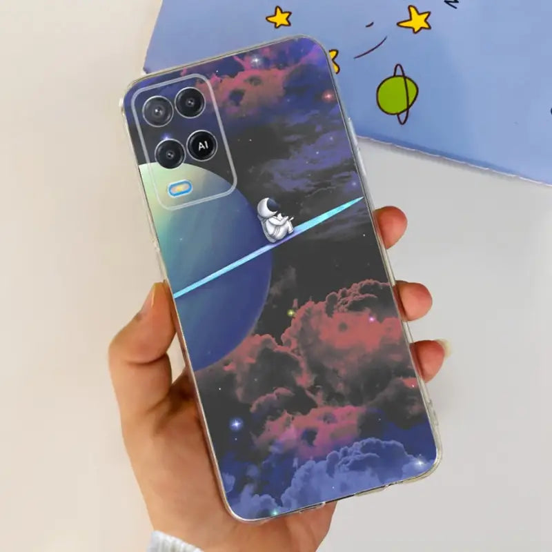 a person holding a phone with a space theme on it