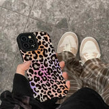 a person holding a phone case with a leopard print