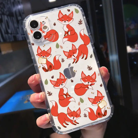 a woman holding a phone case with foxes on it