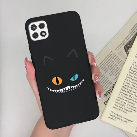 a person holding a phone case with a black cat face