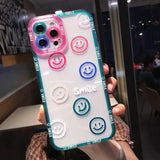 a woman holding up a phone case with smiley faces
