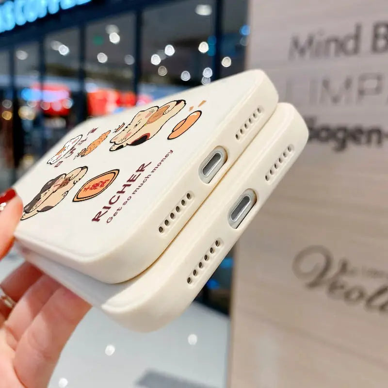 a hand holding a phone case with a cartoon design