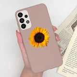 a woman holding a phone case with a sunflower on it