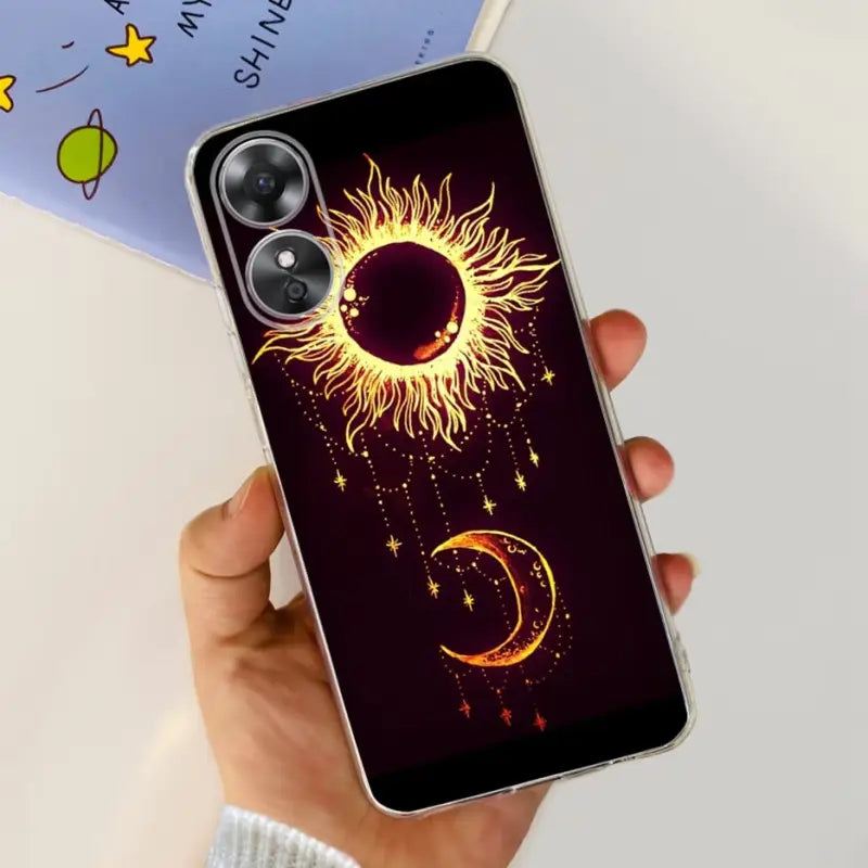 a person holding a phone case with a sun and moon