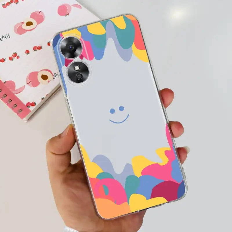 a person holding a phone case with a colorful pattern