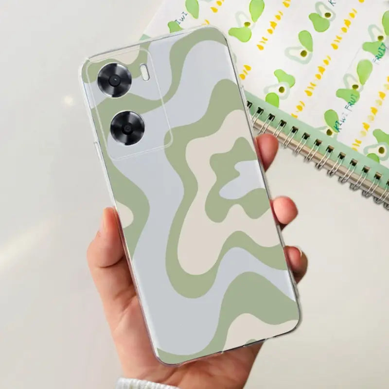 a person holding a phone case with a cam pattern