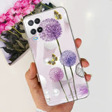 a hand holding a phone case with purple flowers