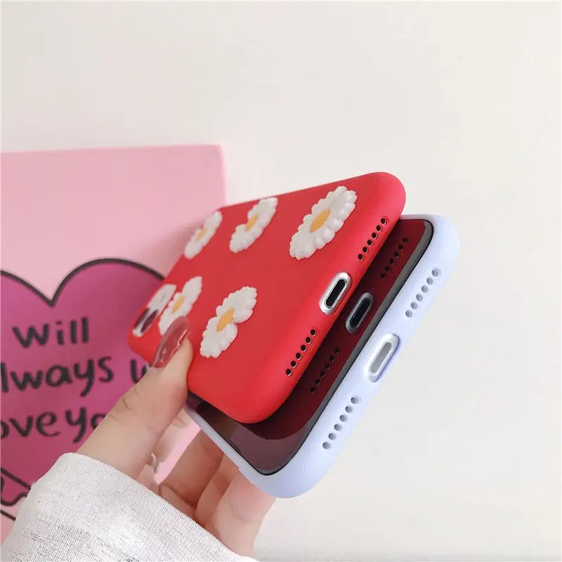 a person holding a phone case with a flower design
