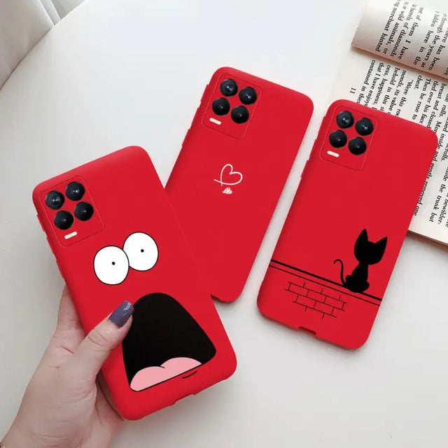 a person holding a red phone case with a black cat on it