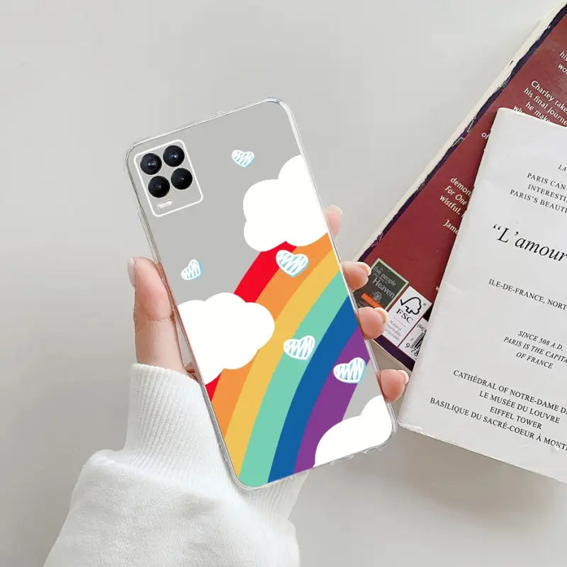 a person holding a phone case with a rainbow rainbow