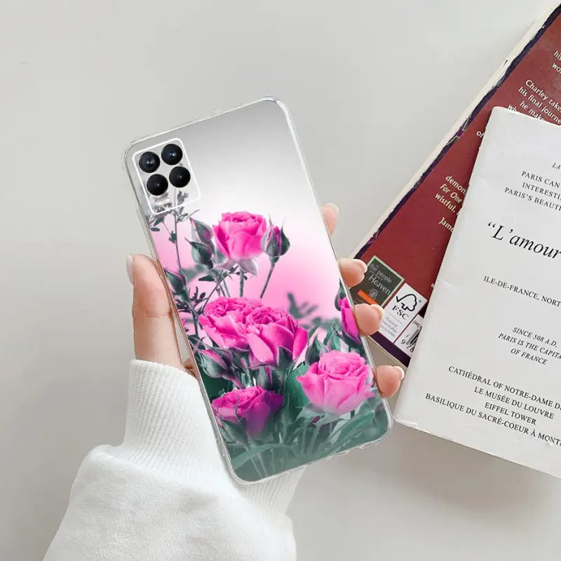 a person holding a phone case with pink roses