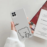 a person holding a phone case with a drawing of a bear