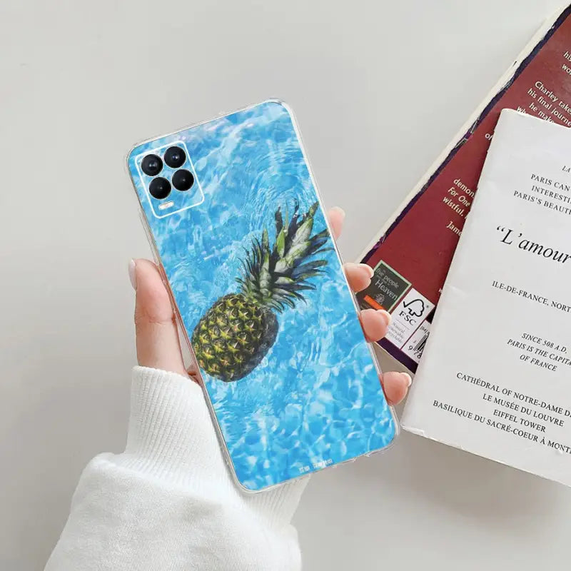 a person holding a phone case with a pine on it