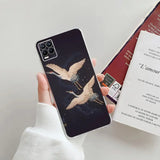 a woman holding a phone case with a bird on it