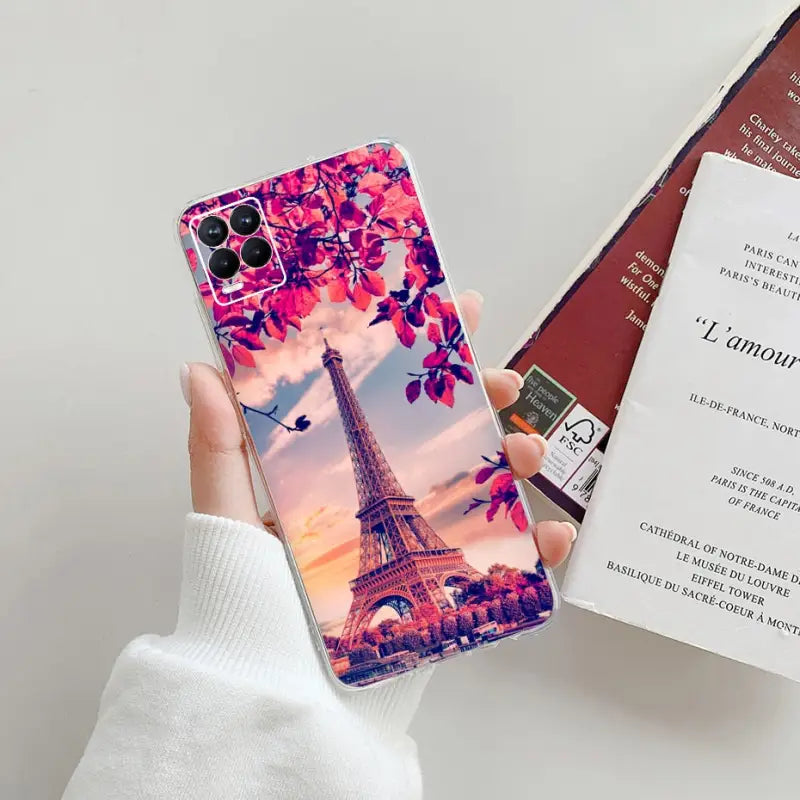 a person holding a phone case with the eiff tower in paris