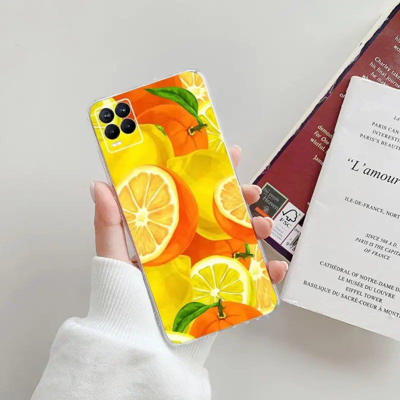 a person holding a phone case with a lemon print