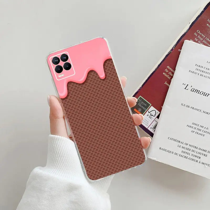 a person holding a phone case with a pink and brown design